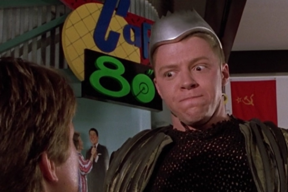 <p><strong>Figure 1.5</strong> When Marty stands up to Griff, we see the logo in the background on cafe signage. Note that it is the reverse of what we see in other places.</p>