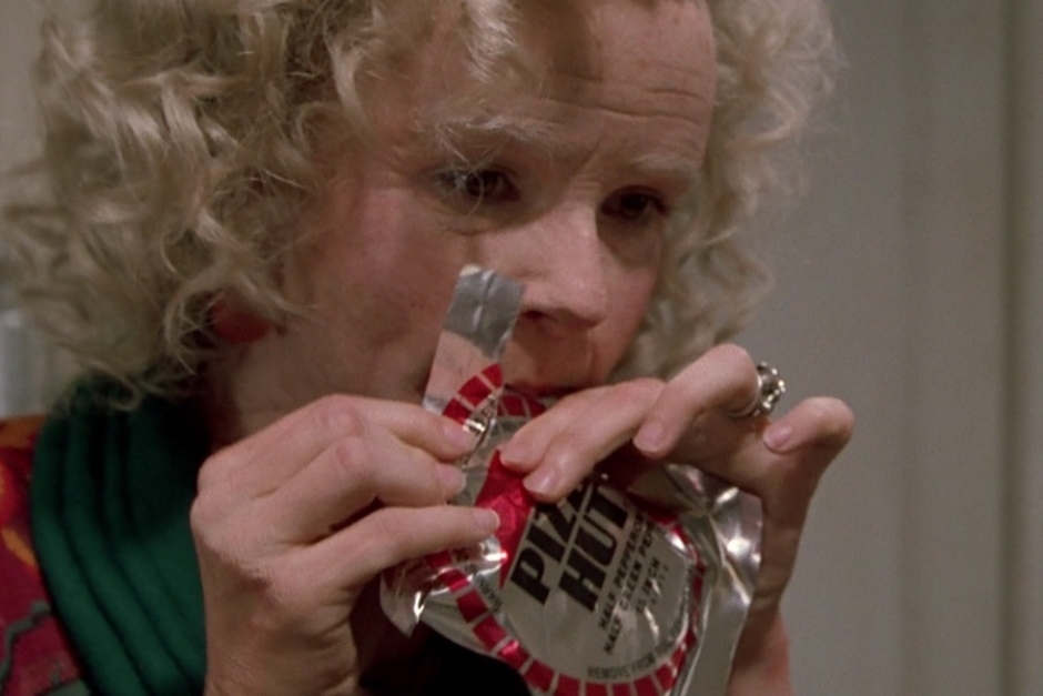<p><strong>Figure 1.3</strong> As Grandma Lorraine opens the package we catch glimpses of the Pizza Hut logo and packaging design.</p>