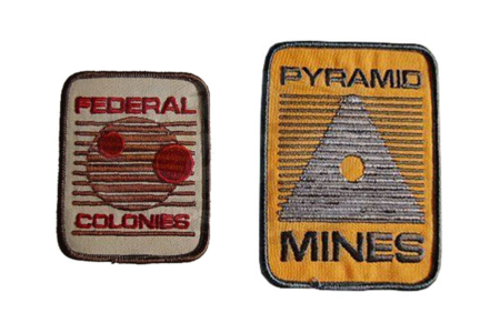 <p><strong>Figure 2.5</strong> Federal Colonies and Pyramid Mines patches side by side for comparison of the logos.</p>