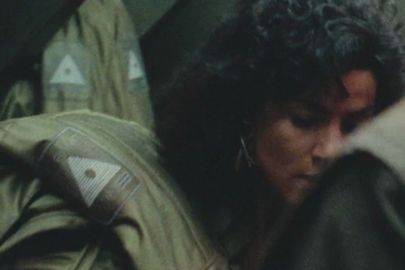 <p><strong>Figure 3.2</strong> The logo on olive drab mining spacesuits, seen as Melina, Quaid and Kuato attempt their escape out an airlock.</p>